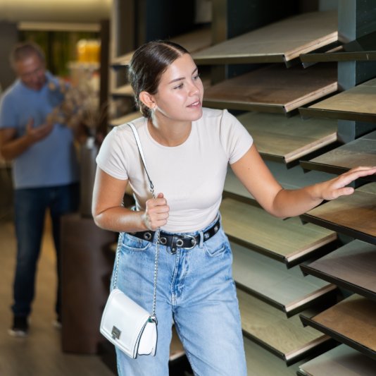 Woman browsing flooring samples in a local Harrisonburg showroom